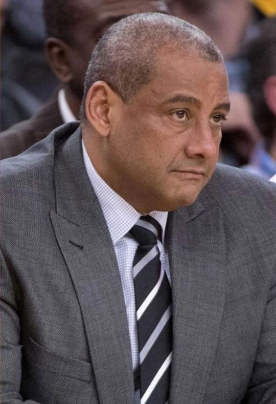 headshot of man in suit and tie